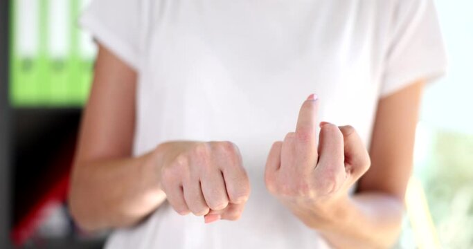 Closeup of woman showing middle finger making fuck you gesture