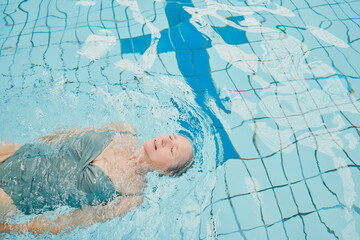 Elderly woman, swimming and pool with float and cardio training for fitness, wellness and physical...