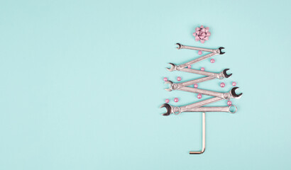 Christmas tree made with wrenches, baubels and a star, new year greeting card with repair tools

