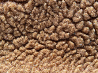 Background texture of light brown wool. Close-up of the surface of sheep's wool