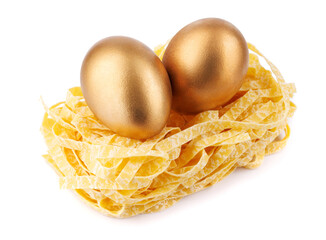 Pasta nest with golden eggs isolated on white background.