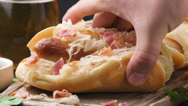 Taking Beer Bratwurst sausage with sauerkraut and bacon.