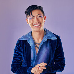 Fashion, punk makeup and Asian man in studio isolated on a purple background. Beauty portrait,...