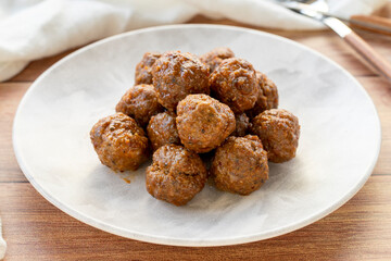 Baked homemade meatballs on wood floor. Local name misket kofte. close up