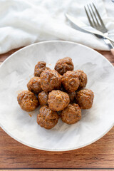 Baked homemade meatballs on wood floor. Local name misket kofte. close up