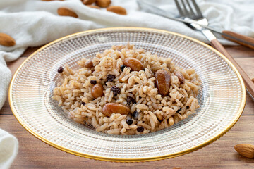 Rice with currants and almonds on a wood background. Traditional Turkish cuisine delicacies. Local name ic pilavi. close up