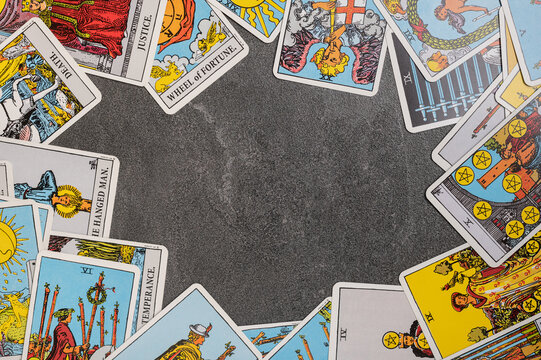 Esoteric tarot cards for fortune telling on a gray stone background