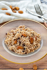 Rice with currants and almonds on a wood background. Traditional Turkish cuisine delicacies. Local name ic pilavi. close up