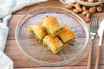 Pistachio baklava. Close-up baklava isolated on wood background. Mediterranean cuisine delicacies