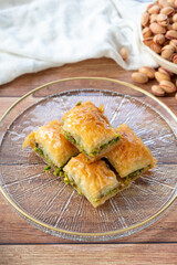 Pistachio baklava. Close-up baklava isolated on wood background. Mediterranean cuisine delicacies