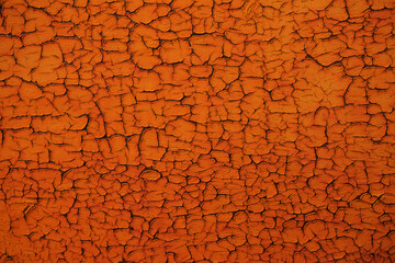 Abstract orange background with cracked texture. Empty back..