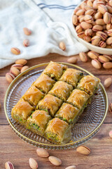 Pistachio baklava. Close-up baklava isolated on wood background. Mediterranean cuisine delicacies