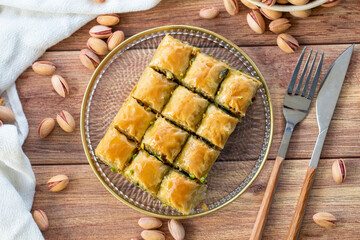 Pistachio baklava. Close-up baklava isolated on wood background. Mediterranean cuisine delicacies