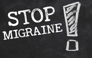 Fototapeta premium stop migraine words written in white chalk on a blackboard.