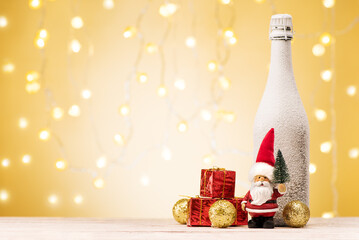 Christmas and New Year holidays background. Santa Claus with gifts, golden deer and bottle champagne on festive banner.