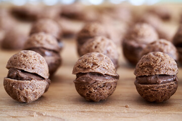 Closeup of Christmas cookies in the form of nuts filled with cocoa cream