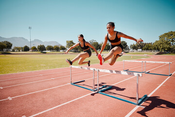 Sport, jump and women runner doing hurdles on stadium track, athlete running race and fitness...