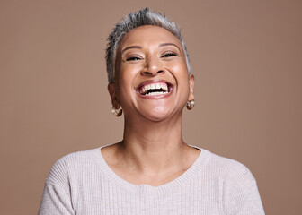 Black woman, beauty and happiness with a senior laughing about funny joke or memory on a brown studio background. Face portrait of a mature model posing for cosmetics, makeup or fashion mockup