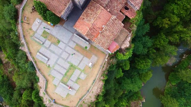Flying over the river, the view point, the church and some typical little streets in Castellfollit de la Roca, typical village in Catalonia, Spain