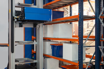 Machine for distribution goods on racks. Robotization warehouse processes. Placement goods in warehouse. Storage shelves inside factory. Fulfillment automation machine. Storage innovative manufactory