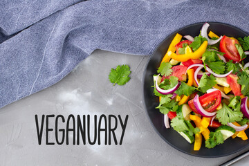 Plate of salad with vegetables and herbs. Vegetarian and vegan diet month in january called Veganuary. - obrazy, fototapety, plakaty