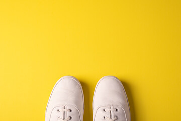 White Sneakers on Yellow Background - Flat Lay Space For Copy 