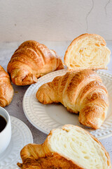 Broken croissant a cup of coffee and French breakfast white background