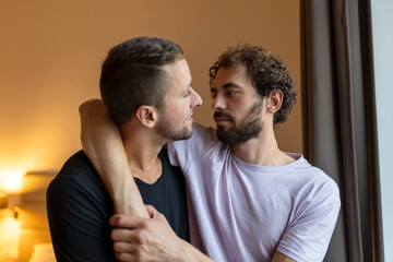 Obraz premium Two young man lgbtq gay couple dating in love hugging enjoying intimate tender sensual moment together kissing with eyes closed