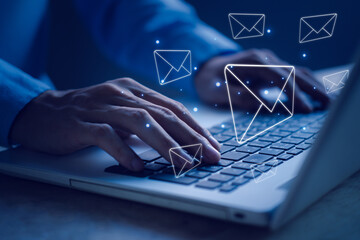Businessman hands typing notebook (Laptop) with email icon and send e-mail or newsletter....