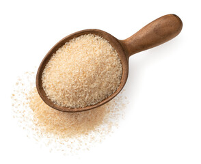 Psyllium husks in the wooden spoon, isolated on white background, top view.