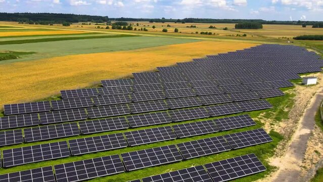Aerial view, massive Solar panel farm on the field, alternative energy