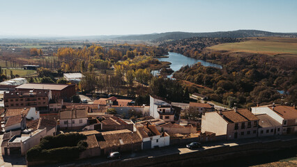 Fototapeta na wymiar Landscape of a village with autumn colors. Drone view