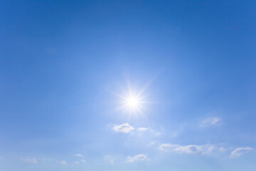 Naklejka na ściany i meble sparkle sun on blue cloudy sky, natural sunny day sky background