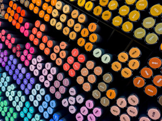 Professional alcohol markers are sold per piece at art stores for artists. Sketching markers on a shelf in an art store.