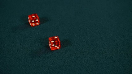 Two red dice roll two and one on green casino gaming table, Craps, Slow motion - Powered by Adobe