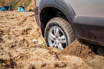Car wheel stuck in sand © Volodymyr Shevchuk