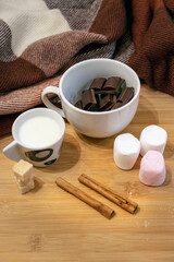 Hot chocolate ingredients on a wooden table, still life