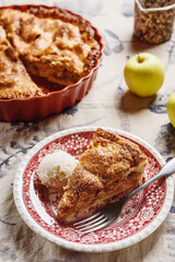 Classic American apple pie served with ice cream on linen tablecloth. Homemade american autumn dessert: sliced apple pie (tart) with cinnamon. Selective focus - 545183753