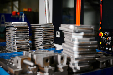 Stacks of silver metal plates on tray at production plant