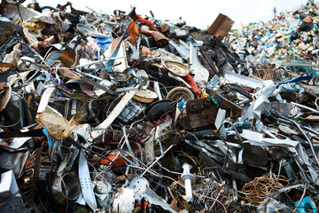 Huge pile of different waste items in recycling plant yard