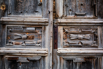 Textured, wooden, carved handmade door close-up.