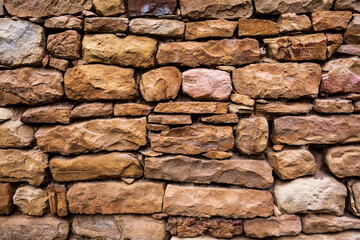 Brown stone texture wall, with seams, stones from mountains, ancient bricks. stone background.