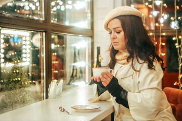 Beautiful woman drinking hot chocolate in a cafe