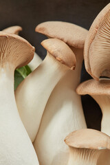 King Oyster mushrooms or Eringi in a bowl a dark background. Shallow depth of field. Flat lay