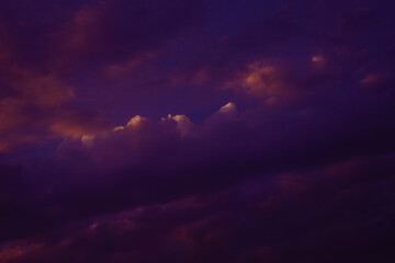 Dark purple violet blue sky with clouds. Colorful dramatic sky background. Thunderstorm, cloudy, storm, rainy.