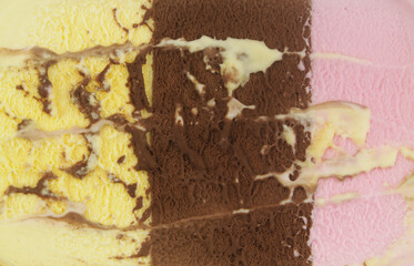 Neapolitan ice-cream background. Vanilla, chocolate and strawberry ice-cream close up.	