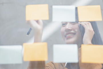 Fototapeta premium Young employee Asian Business woman calling on phone and working with account documents achieves an graph business in workplace finance business concept