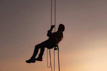 rope access, foreman operation control training the abseiling from the height silhouette - obrazy, fototapety, plakaty