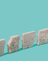 Rock slabs arranged on a pastel blue background. Urban construction minimal concept.