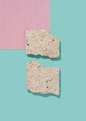 Paper and rock slabs arranged on a minty background. Abstract contrast conceptual template.